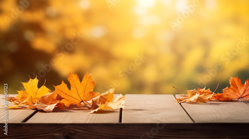 Maple leaves of autumn adorn a wooden tabletop  creating a natural background of falling leaves. A sunny autumn day unfolds in the park  showcasing the beauty of orange foliage. The scene forms a wide