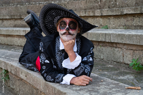 Young man dressed as catrin for day of the dead cellebration photo