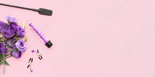 Beautiful flowers and sex toys on pink background with space for text photo