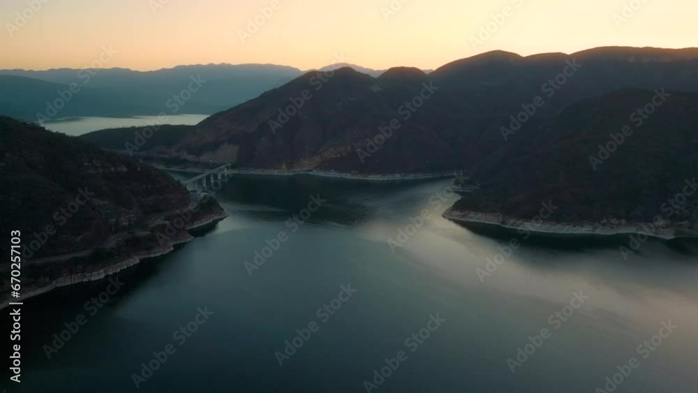 Aerial drone flying over a lake, water dam, with mountains at sunrise. Beautifull dreamy landscape view. Coastline with boats. Pacefull landscape. Cabra Corral, Salta Argentina. Aerial drone flying over a lake, water dam, with mountains at sunrise. Beautifull dreamy landscape view. Coastline with boats. Pacefull landscape. Cabra Corral, Salta Argentina.