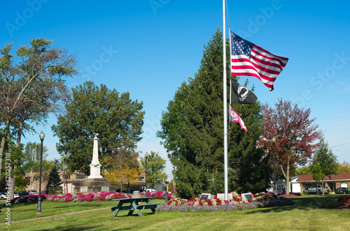 A U.S. flag flies at half staff in the midst of the town square in Twinsburg, Ohio photo