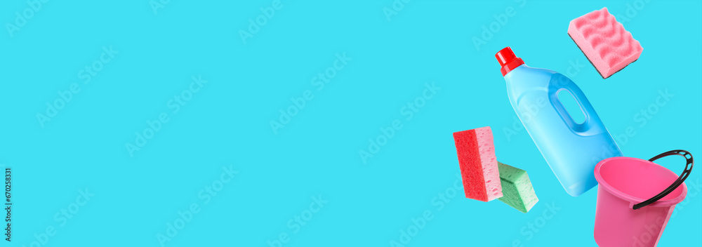 Flying cleaning supplies on light blue background with space for text Flying cleaning supplies on light blue background with space for text