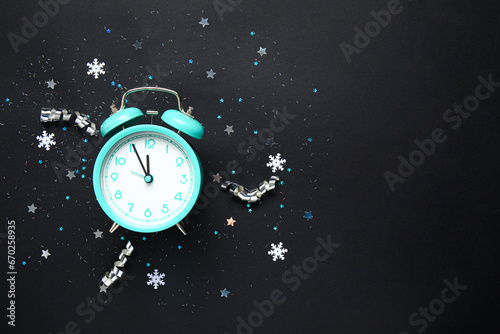 Beautiful composition with alarm clock and Christmas decorations on dark background