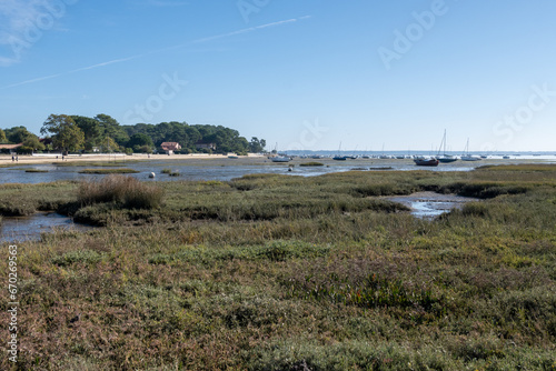 View on Arcachon Bay at low tide with many fisherman's boats and oysters farms, Cap Ferret peninsula, France, southwest of Bordeaux along France's Atlantic coastline © barmalini