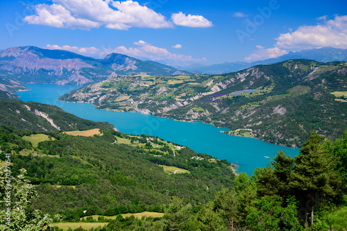 Aerial view on blue Lake of Serre-Poncon  reservoir  border between  Hautes-Alpes  and  Alpes-de-Haute Provence    departments  one of largest in  Western Europe