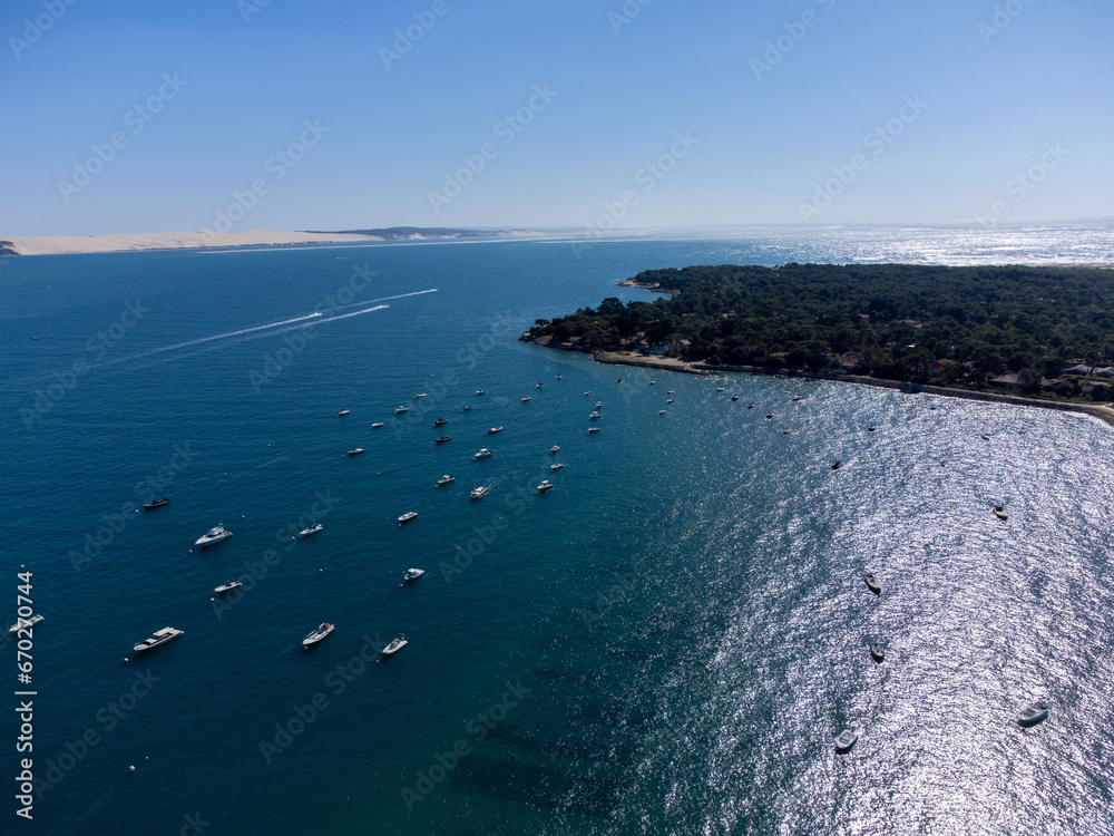Aerial view on Arcachon Bay with many fisherman's boats and oysters farms near Le Phare du Cap Ferret, Cap Ferret peninsula, France, southwest of Bordeaux, France's Atlantic coastline