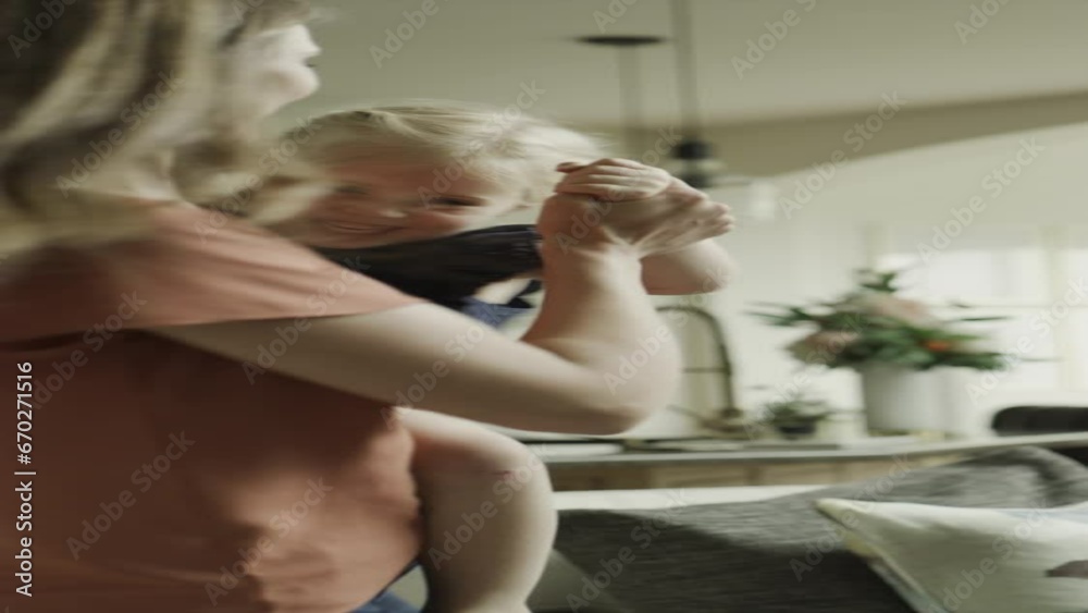 Slow motion of mother carrying and dancing with daughter - vertical video / Cedar Hills, Utah, United States Slow motion of mother carrying and dancing with daughter - vertical video / Cedar Hills, Utah, United States