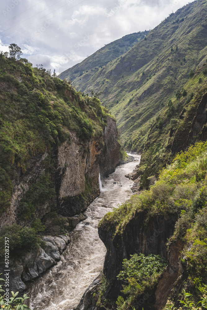 Magnificent view of the river and mountains in a deep canyon in the city of Banos, Ecuador.
