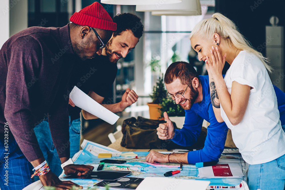 Fototapeta premium male and female multiracial crew satisfied with productive brainstorming session on job