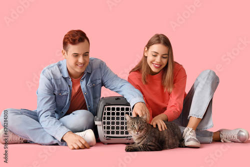 Young couple with cute cat ...