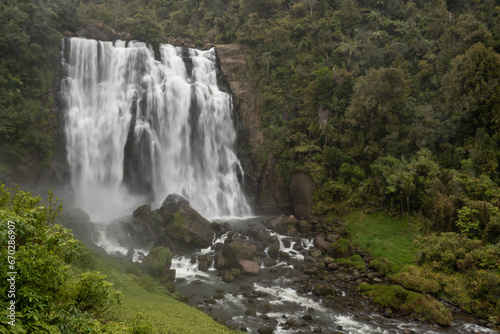 Marokopa Falls in thick forest in the Waitomo area of the Waikato Region  New Zealand. Here the Marokopa River cascades over the undercut greywacke basement rock. 