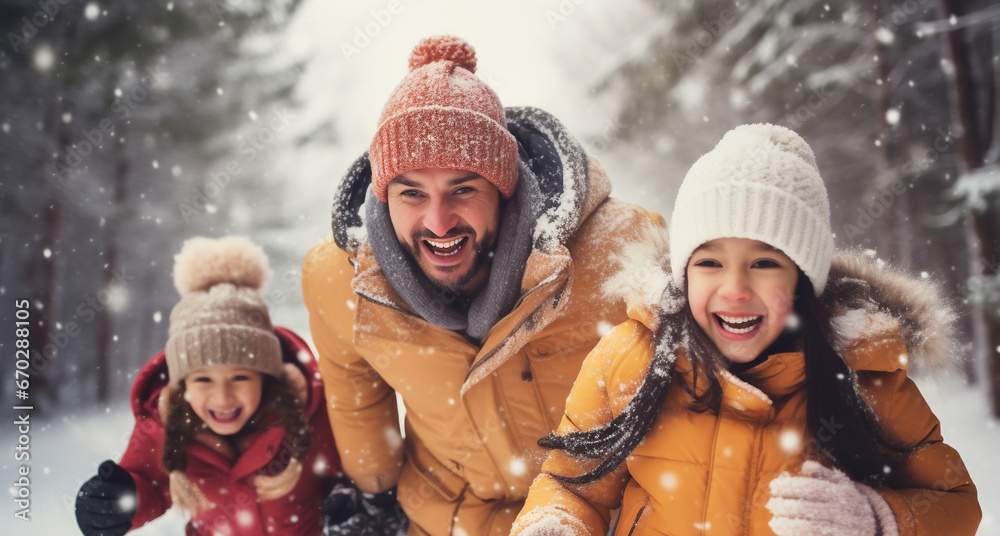 A happy latin family is throwing snowballs at each other playfully with winter coats and wearing winter hats in a in snow covered country landscape during a bright day in winter while snowing