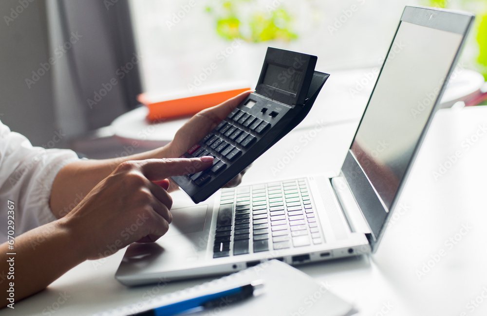 hands with calculator and laptop hands with calculator and laptop