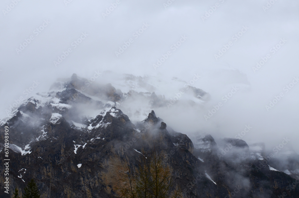 Picturesque view of mountain covered with fog