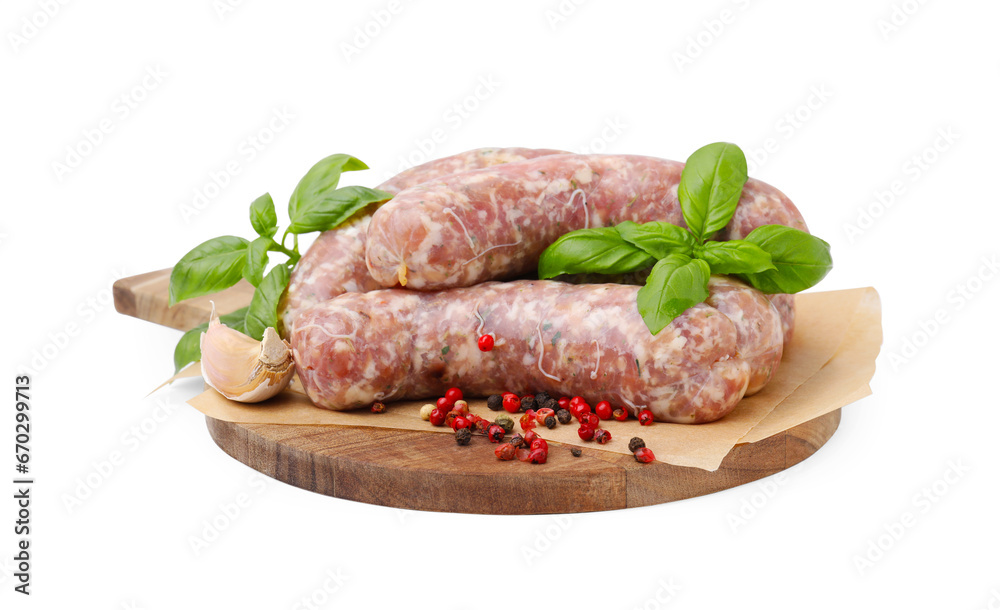 Wooden board with raw homemade sausages and different spices isolated on white Wooden board with raw homemade sausages and different spices isolated on white