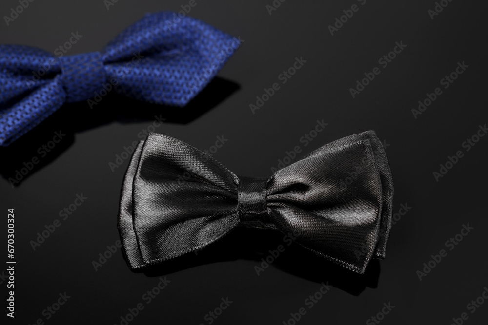 Stylish black bow tie on dark surface Stylish black bow tie on dark surface