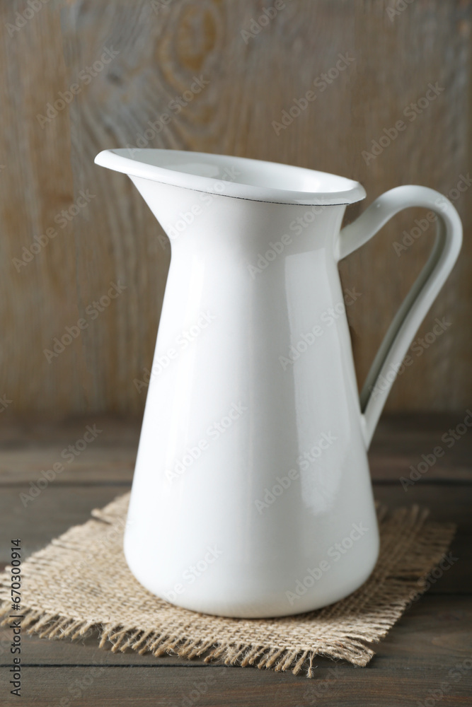 One beautiful white jug on wooden table One beautiful white jug on wooden table