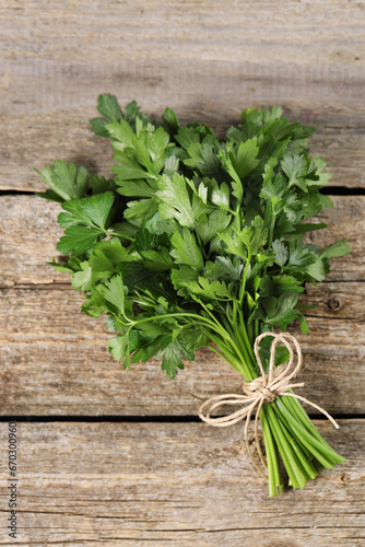 Bunch of fresh green parsley leaves on wooden table, top view