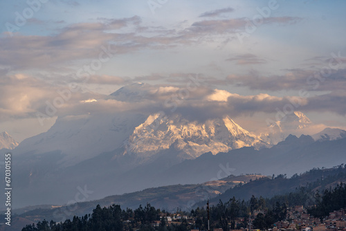 Magnificent sunset view of mountain peaks covered with snow at sunset in the Peruvian city of Huaraz.