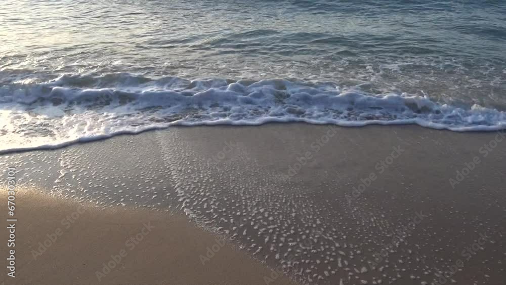 Ocean waves crash on the beach at dusk. Ocean waves crash on the beach at dusk.