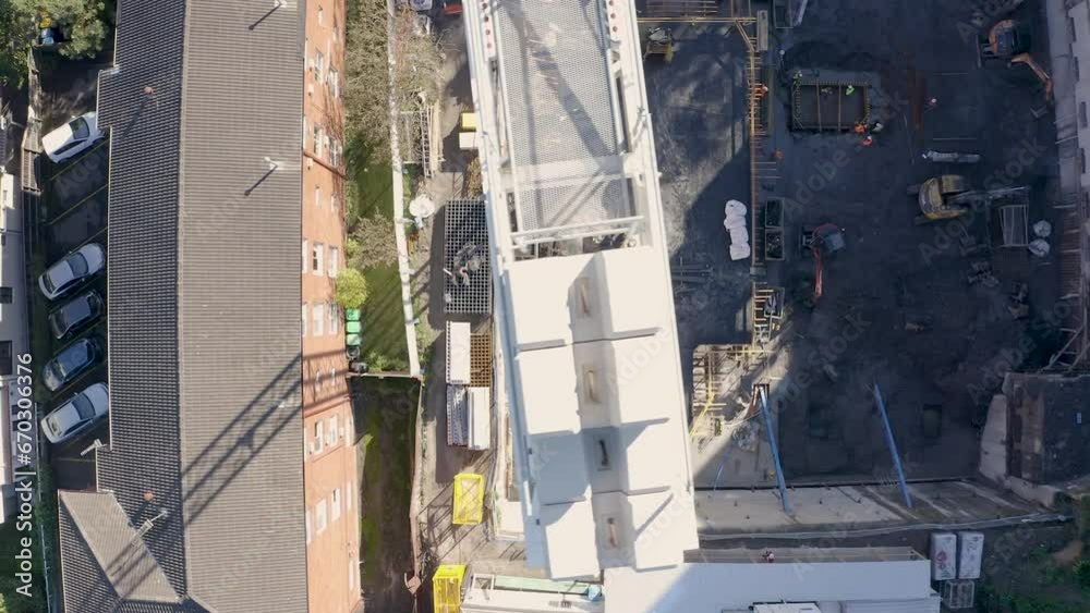 Aerial flight over a demolition site with high tower cranes. Heavy machinery and construction workers in safety gear.. Aerial flight over a demolition site with high tower cranes. Heavy machinery and construction workers in safety gear..