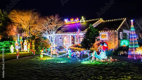 Small American home exterior decorated with colorful festive holiday lights