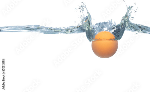 Ping Pong ball falls into water and creates air bubbles on surface. PingPong Table Tennis orange ball drop hit smash to clear water and deep to bubble. White background isolated freeze motion