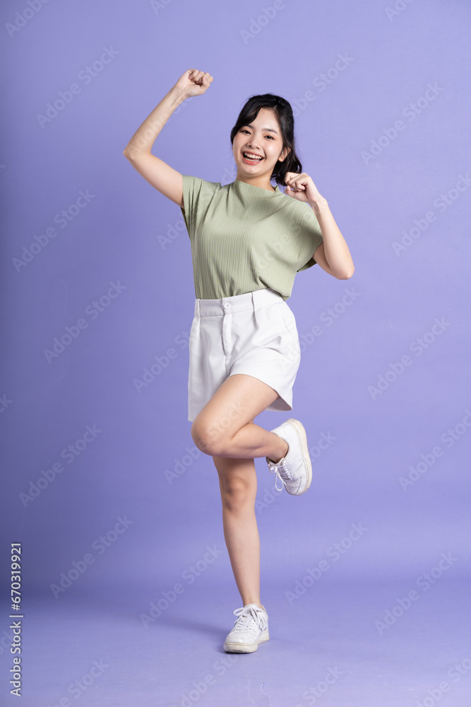 Portrait of beautiful Asian woman posing on purple background Portrait of beautiful Asian woman posing on purple background
