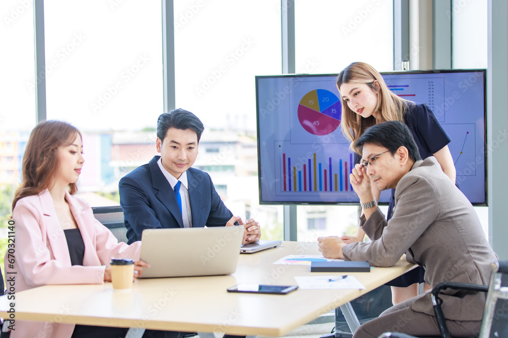 Fototapeta premium Asian professional successful male and female businessman businesswoman partnership colleagues in formal business suit sitting standing listening to presenter in meeting room in company office