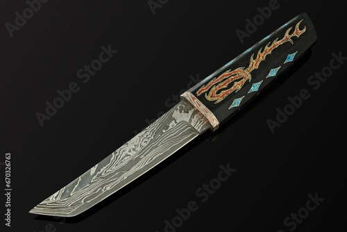 hand-forged Japanese samurai knife tanto with inlays in the form of hieroglyphs in black dener on a black background