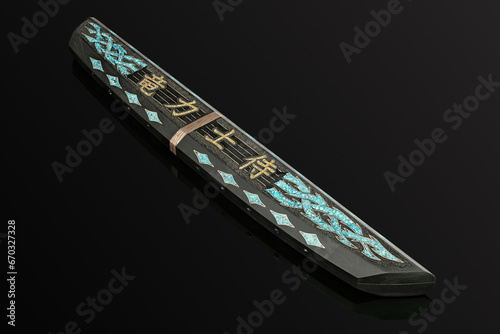 hand-forged Japanese samurai knife tanto with inlays in the form of hieroglyphs in black dener on a black background
