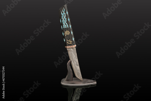 hand-forged Japanese samurai knife tanto with inlays in the form of hieroglyphs in black dener on a black background