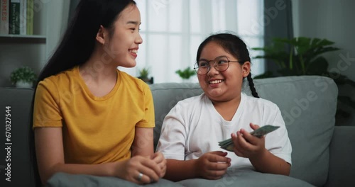 Footage of young woman giving dollars money with teen girl for doing great work at home.