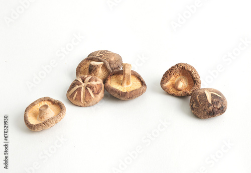 Shiitake mushrooms or lentinus edodes foods that are healthy, cultivated in Japan and China. Dried mushrooms isolated on white background. Full depth of field. photo