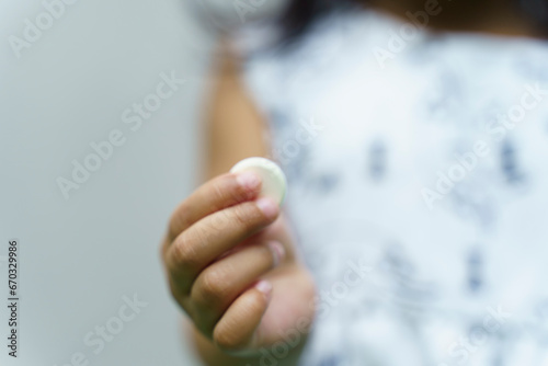 close up of child hand holds medical pills, Multivitamin pill containing amino acid on child hand.