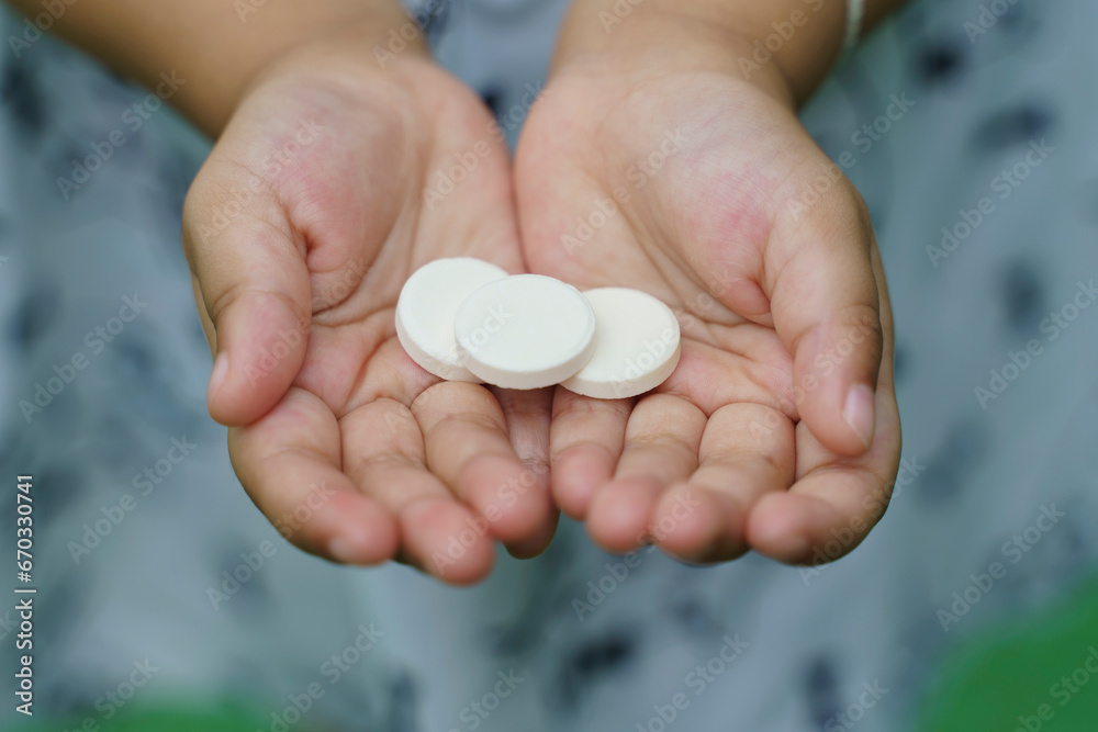 close up of medical pills, Multivitamin pill containing amino acid on child hand. close up of medical pills, Multivitamin pill containing amino acid on child hand.