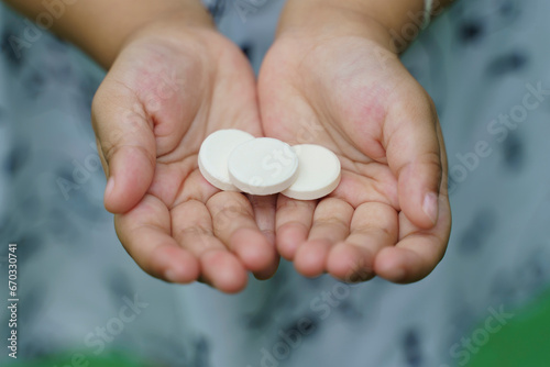 close up of medical pills, Multivitamin pill containing amino acid on child hand.