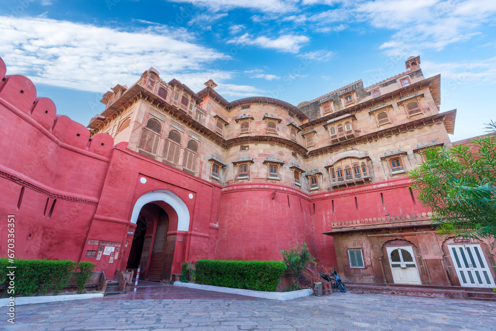 Blue sky and white clouds, red exterior walls and golden buildings. Junagarh Fort is located in Bikaner, Rajasthan, India
