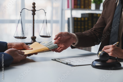 Government tax officials, legal advisers taking bribes of citizens wrapped in brown envelopes. Opening the annual tax evasion, the concept of bribing tax evader officials.