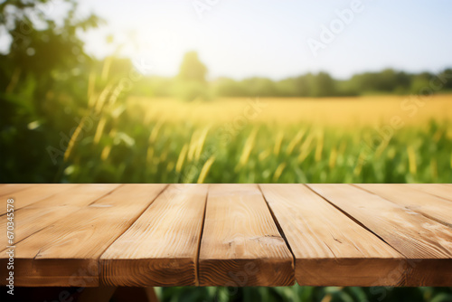 Empty wooden table top on blur field background