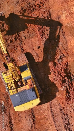 Preparing area for built home excavator loads earth into dump truck on construction site