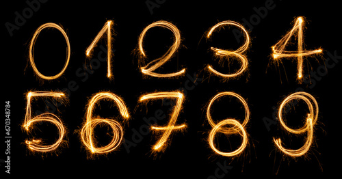 Fireworks numbers 0-9 Burning sparkler Numbers isolated on black background. Sparkler firework light alphabet number zero to nine. Numbers Alphabet of Sparklers to overlay on texture for happy design photo