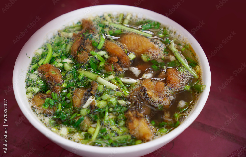 Fried fish noodles garnished with green onions and celery Fried fish noodles garnished with green onions and celery
