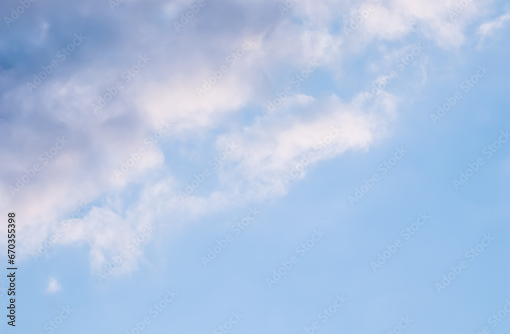Blue sky background with white and pink clouds at sunset Blue sky background with white and pink clouds at sunset