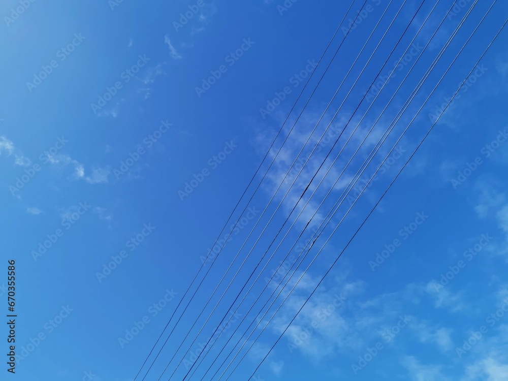 Power transmission lines against deep blue sky with copy space Power transmission lines against deep blue sky with copy space
