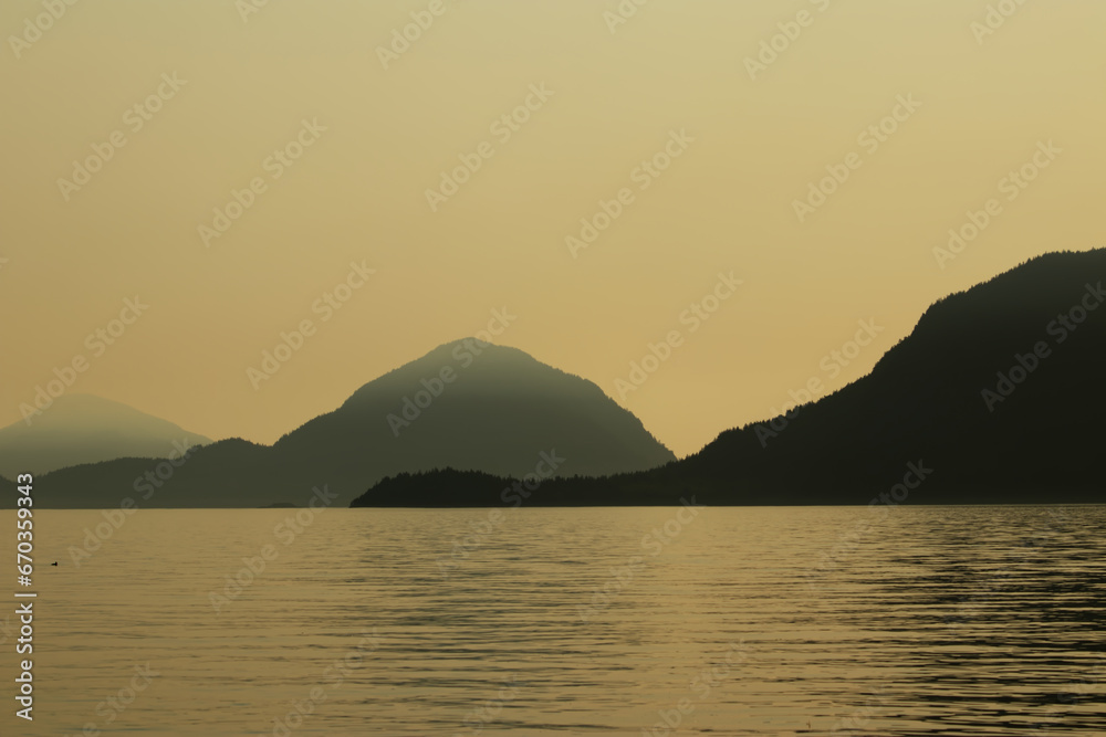 Mountains silhouette in the horizon with sea - sunset Mountains silhouette in the horizon with sea - sunset