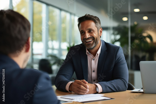 Indian businessman being interviewed at his new car dealership photo