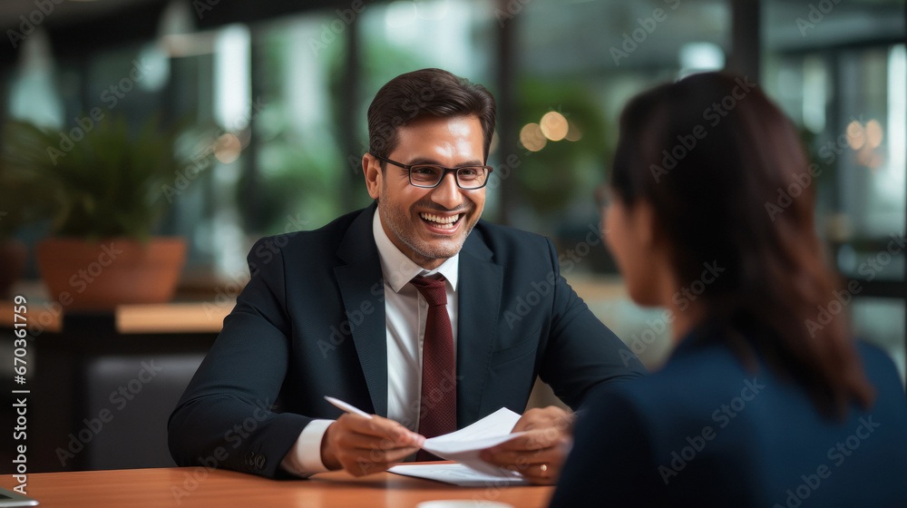 Indian insurance sales man or investing advisor explaining the plan to her client.