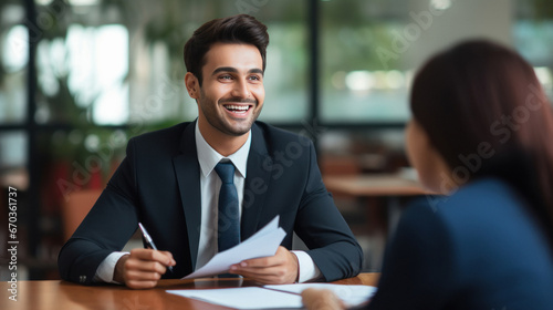 Indian insurance sales man or investing advisor explaining the plan to her client.