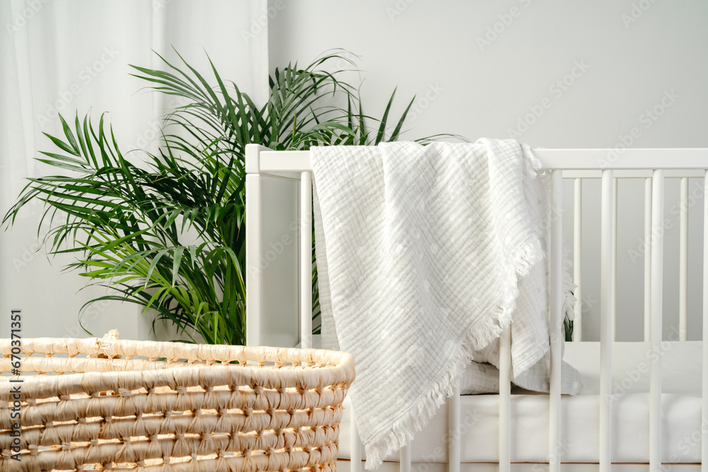 Baby bed and basket in nursery room interior Baby bed and basket in nursery room interior
